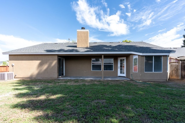 5873 W Wathen, Fresno, CA 93722 - rear view of property featuring a chimney, a patio area, a shingled roof, stucco siding, and central AC