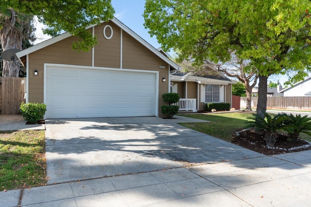 5873 W Wathen, Fresno, CA 93722 - view of front of house with concrete driveway and an attached garage