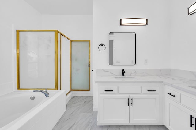 5873 W Wathen, Fresno, CA 93722 - full bath featuring marble look tiles, a stall shower, vanity, and a garden tub