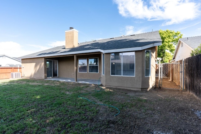 5873 W Wathen, Fresno, CA 93722 - rear view of property featuring a chimney, a patio, stucco siding, a gate, and roof with shingles