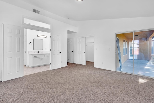 5873 W Wathen, Fresno, CA 93722 - unfurnished bedroom with light colored carpet, vaulted ceiling, access to outside, a sink, and baseboards