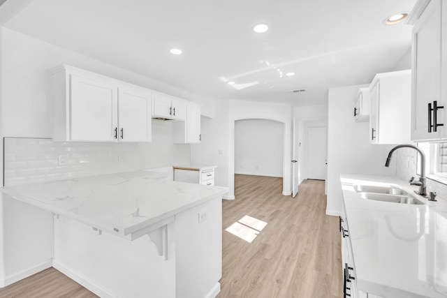 5873 W Wathen, Fresno, CA 93722 - kitchen featuring a sink, light stone counters, recessed lighting, and white cabinetry