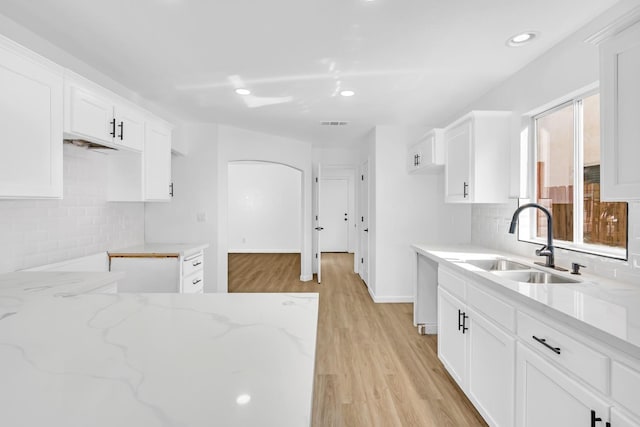 5873 W Wathen, Fresno, CA 93722 - kitchen with a sink, light stone countertops, light wood-style floors, backsplash, and recessed lighting