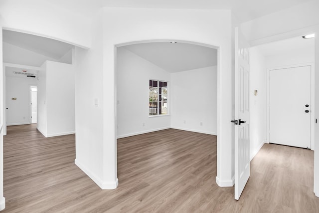 5873 W Wathen, Fresno, CA 93722 - foyer featuring arched walkways, vaulted ceiling, wood finished floors, and baseboards