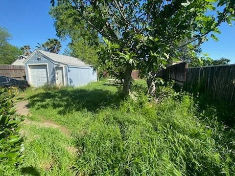 view of yard featuring an outbuilding and a fenced backyard