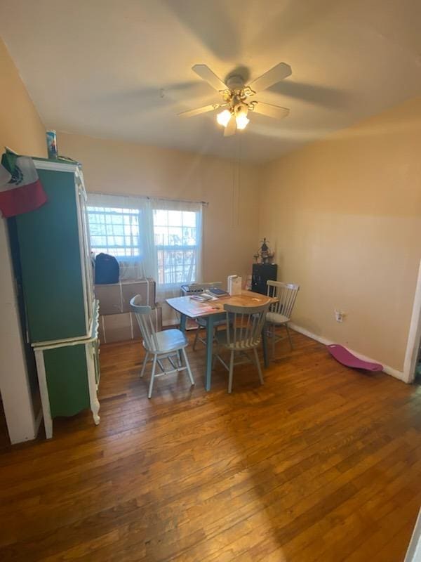 dining room featuring ceiling fan, baseboards, and wood finished floors