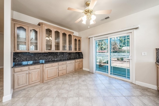 18778 Shore Dr, Madera, CA 93638 - kitchen with tasteful backsplash, visible vents, glass insert cabinets, and a ceiling fan