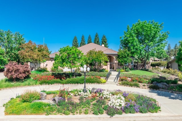 18778 Shore Dr, Madera, CA 93638 - view of property hidden behind natural elements featuring a chimney and stairway