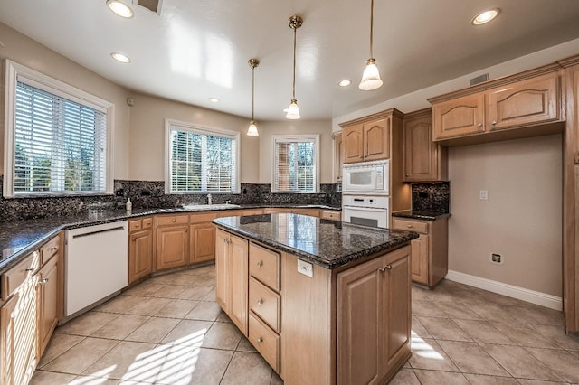 18778 Shore Dr, Madera, CA 93638 - kitchen featuring dark stone counters, white appliances, tasteful backsplash, a center island, and a sink