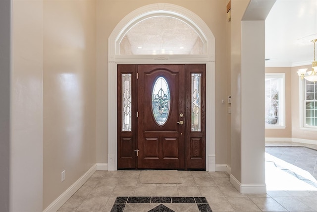 18778 Shore Dr, Madera, CA 93638 - entrance foyer with crown molding, light tile patterned floors, a notable chandelier, and baseboards