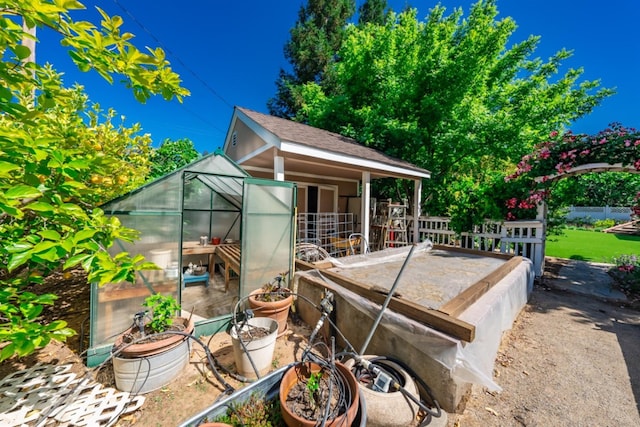 18778 Shore Dr, Madera, CA 93638 - view of patio / terrace featuring fence, a greenhouse, and an outbuilding