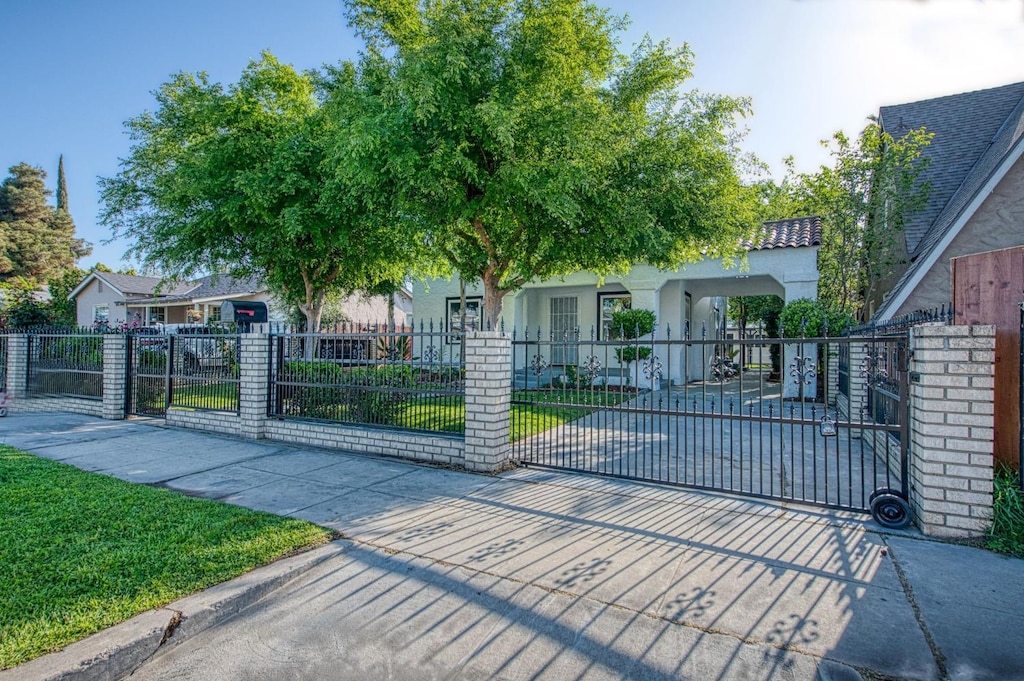 view of gate with a fenced front yard