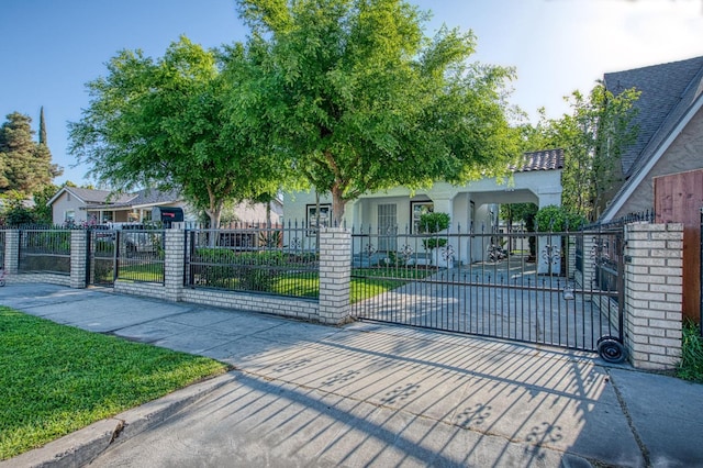 view of gate with a fenced front yard