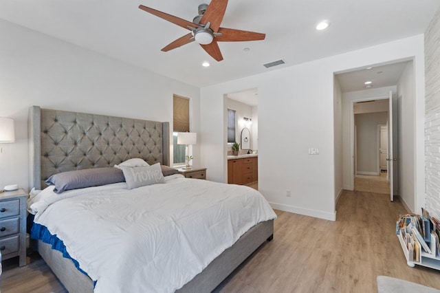 bedroom with connected bathroom, visible vents, recessed lighting, light wood finished floors, and baseboards