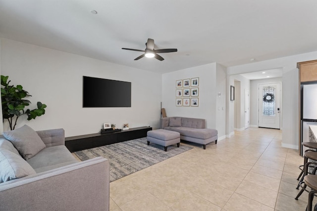 living room featuring light tile patterned floors and ceiling fan