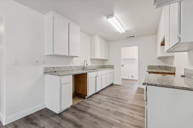 2464 S Kirk St, Fresno, CA 93706 - kitchen featuring light wood-style flooring, light stone counters, and white cabinets