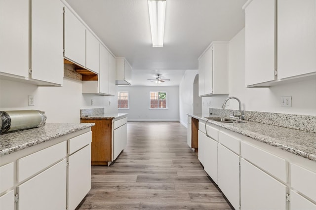 2464 S Kirk St, Fresno, CA 93706 - kitchen with a ceiling fan, light wood-style floors, white cabinets, and open floor plan