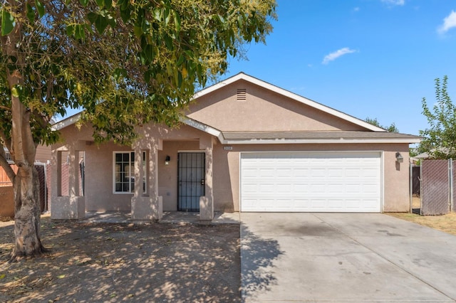 2464 S Kirk St, Fresno, CA 93706 - single story home with stucco siding, driveway, and a garage