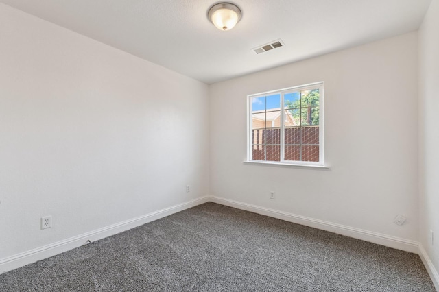 2464 S Kirk St, Fresno, CA 93706 - spare room featuring dark colored carpet and baseboards