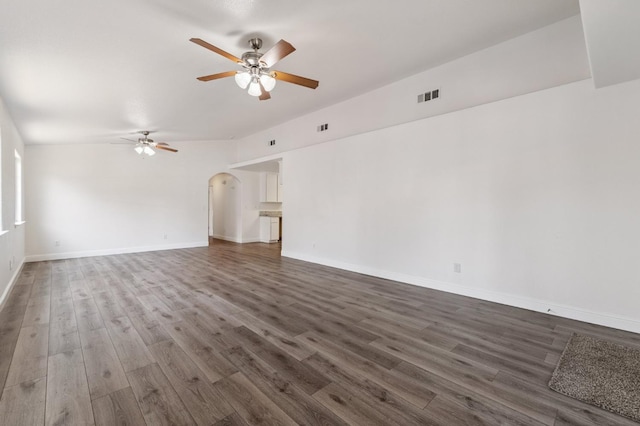 2464 S Kirk St, Fresno, CA 93706 - unfurnished living room featuring a ceiling fan, dark wood-type flooring, and arched walkways