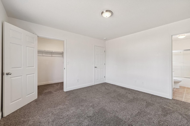 2464 S Kirk St, Fresno, CA 93706 - unfurnished bedroom featuring carpet flooring, a spacious closet, a closet, and ensuite bath