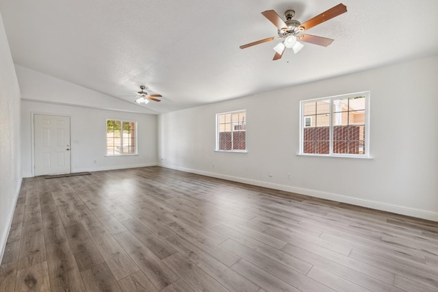 2464 S Kirk St, Fresno, CA 93706 - empty room featuring a ceiling fan, vaulted ceiling, and wood finished floors