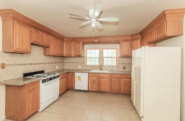 kitchen with tasteful backsplash, white appliances, light tile patterned floors, ceiling fan, and a sink