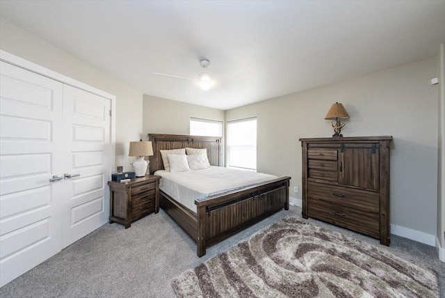 bedroom with light colored carpet, baseboards, and ceiling fan