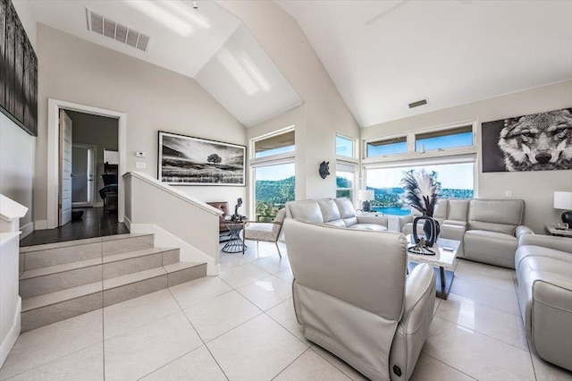 living room featuring light tile patterned flooring, visible vents, and a wealth of natural light