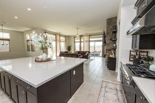 kitchen with recessed lighting, light countertops, under cabinet range hood, visible vents, and stainless steel gas cooktop