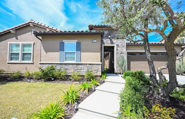 mediterranean / spanish home with a garage, a front yard, stucco siding, and stone siding