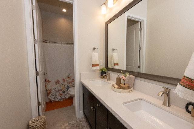 full bath with a sink, toilet, double vanity, and a shower with shower curtain