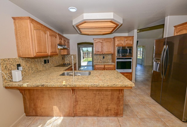 10089 N Baird Ave, Fresno, CA 93730 - kitchen featuring light tile patterned floors, light stone countertops, tasteful backsplash, a peninsula, and black appliances