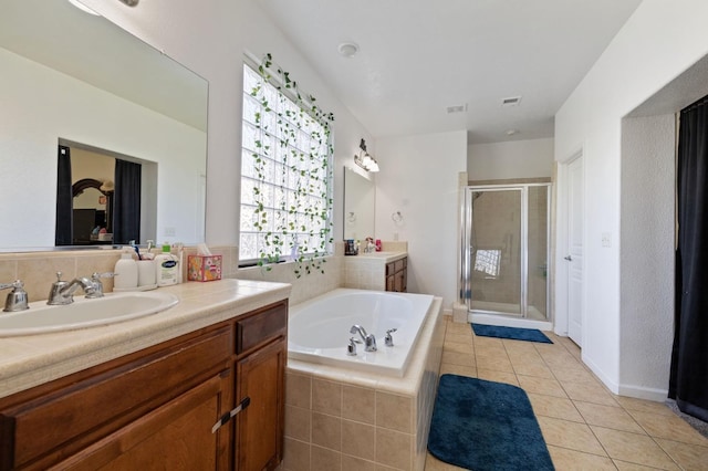 2594 S Duke Ave, Fresno, CA 93727 - bathroom featuring a garden tub, two vanities, a shower stall, tile patterned flooring, and a sink