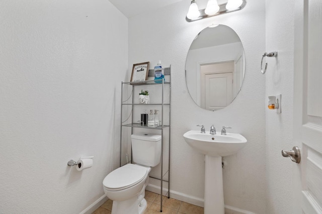 2594 S Duke Ave, Fresno, CA 93727 - half bathroom featuring tile patterned flooring, toilet, baseboards, and a sink