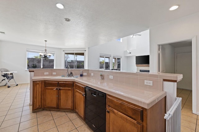 2594 S Duke Ave, Fresno, CA 93727 - kitchen featuring tasteful backsplash, tile counters, black dishwasher, light tile patterned flooring, and a sink