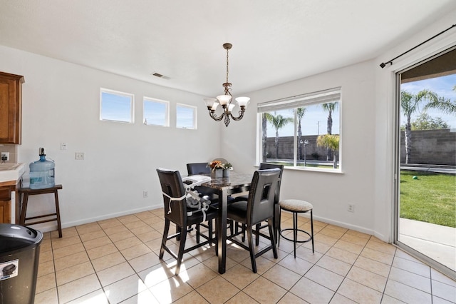 2594 S Duke Ave, Fresno, CA 93727 - dining room featuring baseboards, light tile patterned flooring, a notable chandelier, and visible vents