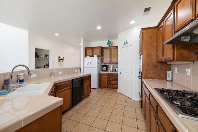 2594 S Duke Ave, Fresno, CA 93727 - kitchen with black appliances, tile counters, a sink, and visible vents