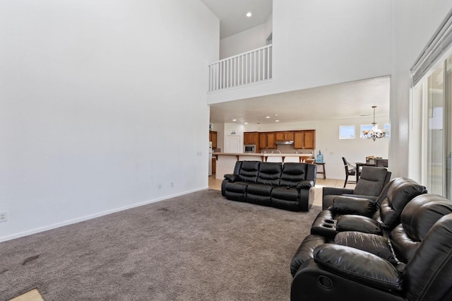 2594 S Duke Ave, Fresno, CA 93727 - living room with baseboards, an inviting chandelier, light carpet, recessed lighting, and a high ceiling