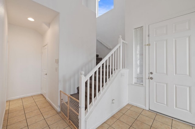 2594 S Duke Ave, Fresno, CA 93727 - foyer featuring light tile patterned floors, baseboards, and stairs