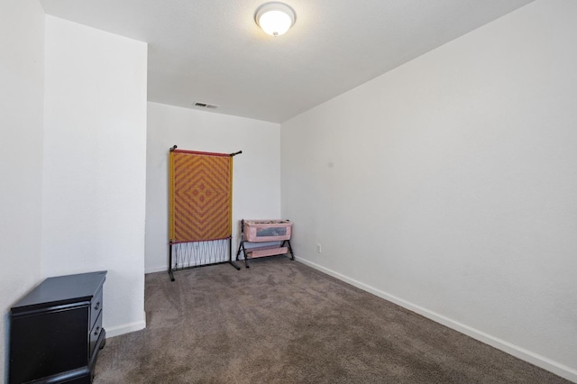 2594 S Duke Ave, Fresno, CA 93727 - spare room featuring baseboards, dark colored carpet, and visible vents
