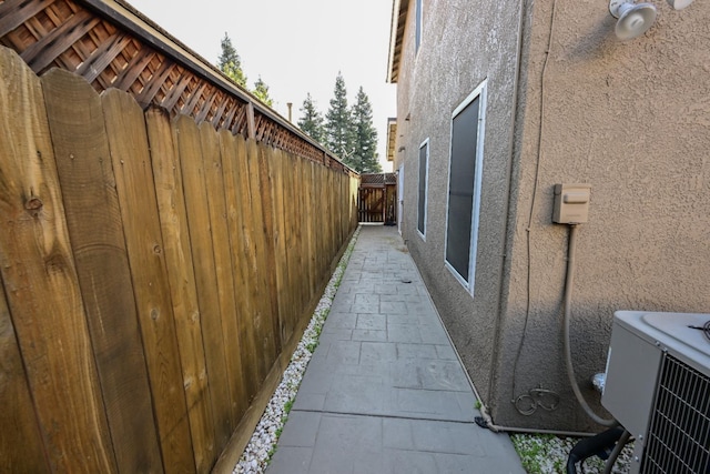 738 Century Ln, Clovis, CA 93612 - view of side of home featuring central AC unit, stucco siding, and fence