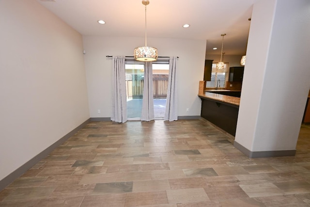 738 Century Ln, Clovis, CA 93612 - unfurnished dining area with baseboards, recessed lighting, an inviting chandelier, and wood finished floors