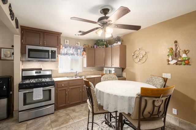 607 N 4th St, Fresno, CA 93702 - kitchen featuring ceiling fan, appliances with stainless steel finishes, a sink, light countertops, and visible vents