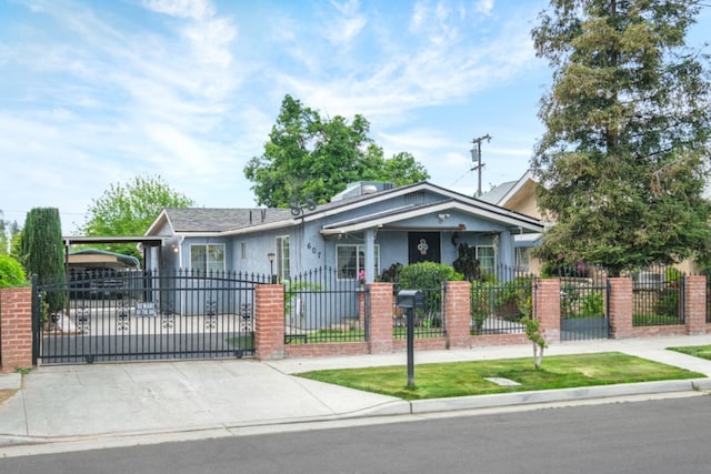 607 N 4th St, Fresno, CA 93702 - view of front of home featuring driveway, a fenced front yard, a gate, and stucco siding