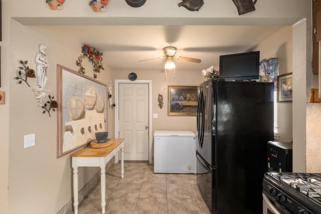 607 N 4th St, Fresno, CA 93702 - kitchen featuring freestanding refrigerator, light tile patterned flooring, fridge, ceiling fan, and light countertops