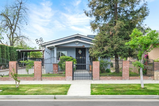607 N 4th St, Fresno, CA 93702 - view of front of home with a gate, a fenced front yard, and stucco siding