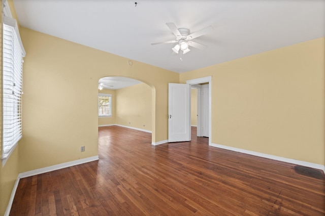 811 E Cambridge Ave, Fresno, CA 93704 - unfurnished room with a ceiling fan, arched walkways, hardwood / wood-style flooring, and baseboards