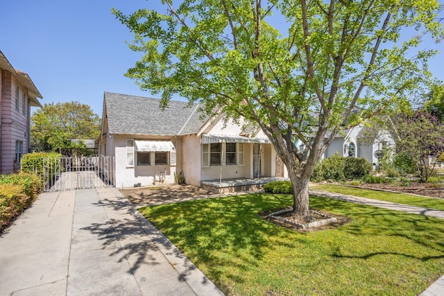 811 E Cambridge Ave, Fresno, CA 93704 - view of front of property featuring stucco siding, a front yard, a shingled roof, concrete driveway, and a gate