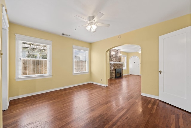 811 E Cambridge Ave, Fresno, CA 93704 - empty room featuring ceiling fan, arched walkways, hardwood / wood-style flooring, and baseboards